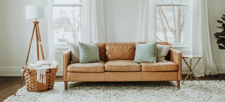 A minimalist living room with a sofa and floor lamp