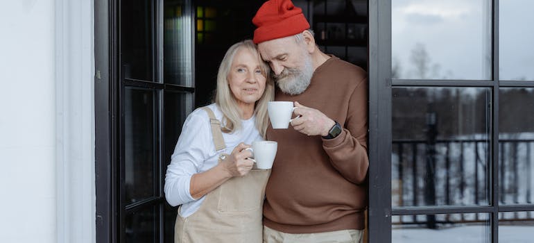 Elderly man and woman standing by the door after downsizing during the festivities