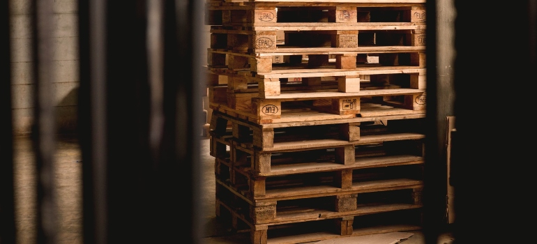 A stack of palettes for mobile storage helping mitigate impact of climate on storage