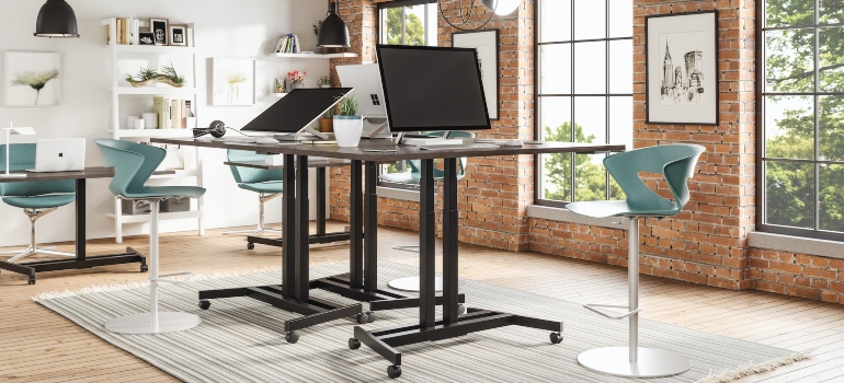 black laptop computer on a standing desk can simplify your SMA office relocation