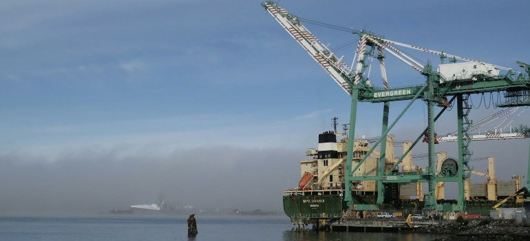A large crane sitting on top of a body of water in Pigeon Creek Trail, Everett