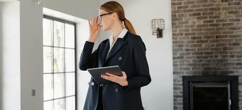 Woman with a checklist is trying to balance work and moving in Seattle