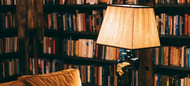 Turned on Floor Lamp near Sofa on a Library Room