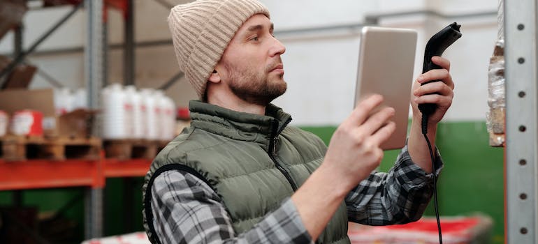 Man in Green is Holding Silver Smartphone and scanning