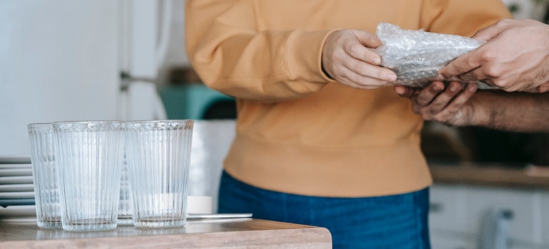 A Woman Holding A Wrapped Plate