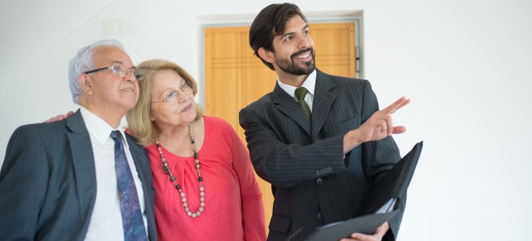a real estate agent talking to an Elderly Couple