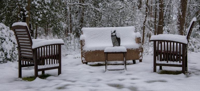 Outdoor furniture covered with snow