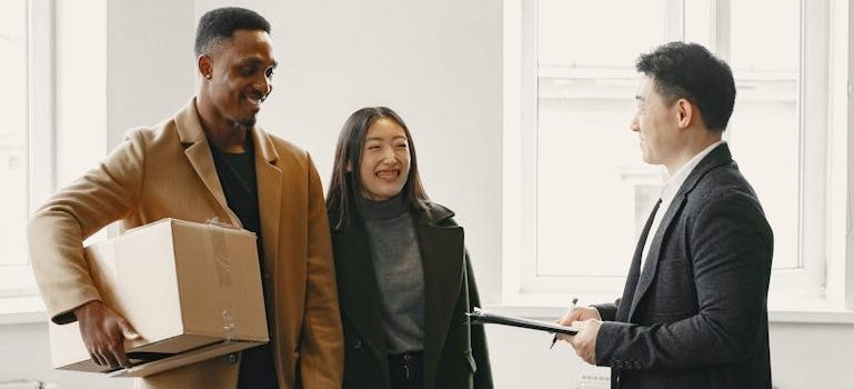 Men and Woman Talking in a Room with moving boxes