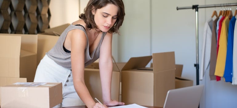 a woman packing boxes in one of the businesses that use self-storage