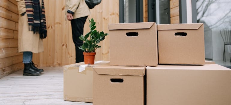 A couple with boxes on a porch