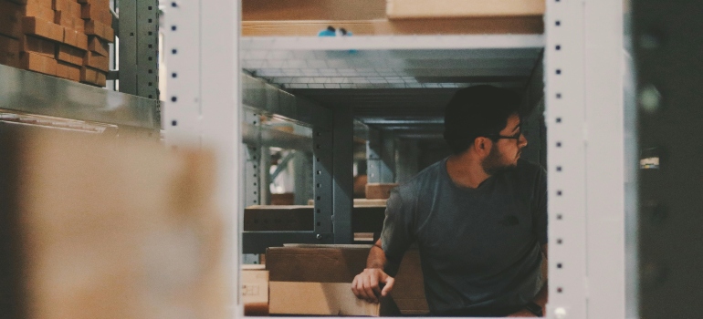Man Under a Bunch of Large Shelves