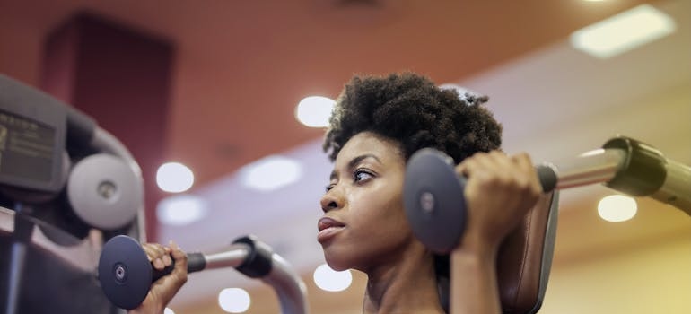 Woman Sitting on Exercise Equipment