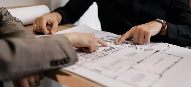 two people looking over a floor plan