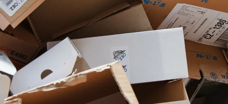 A pile of used cardboard boxes implies low-quality packing supplies.