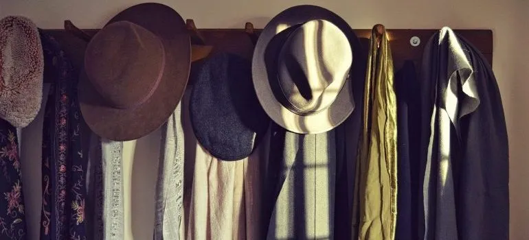 Hats and scarves on a rack.
