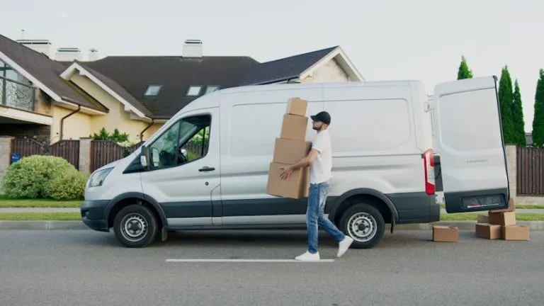 A man carrying a stack of boxes
