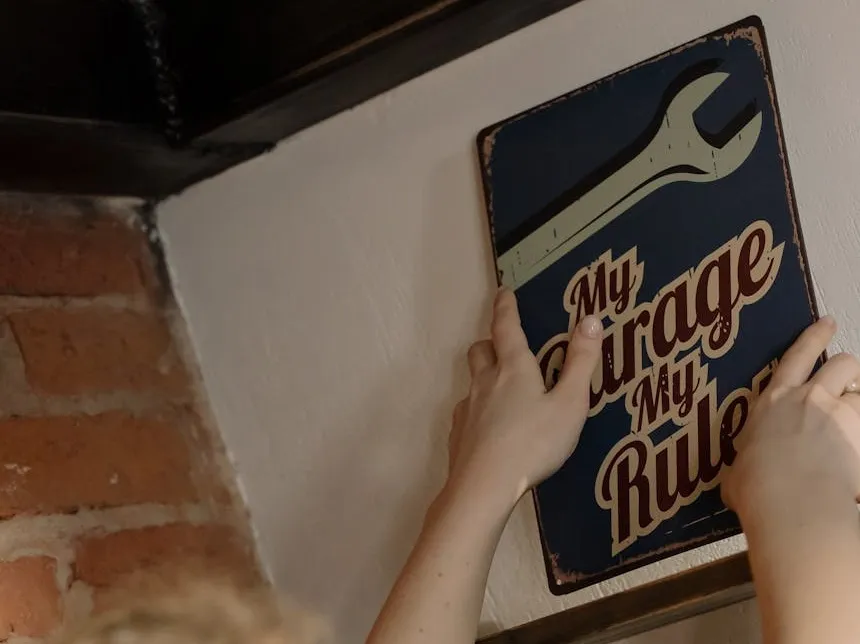 A person setting up a plate "My Garage, my rules"
