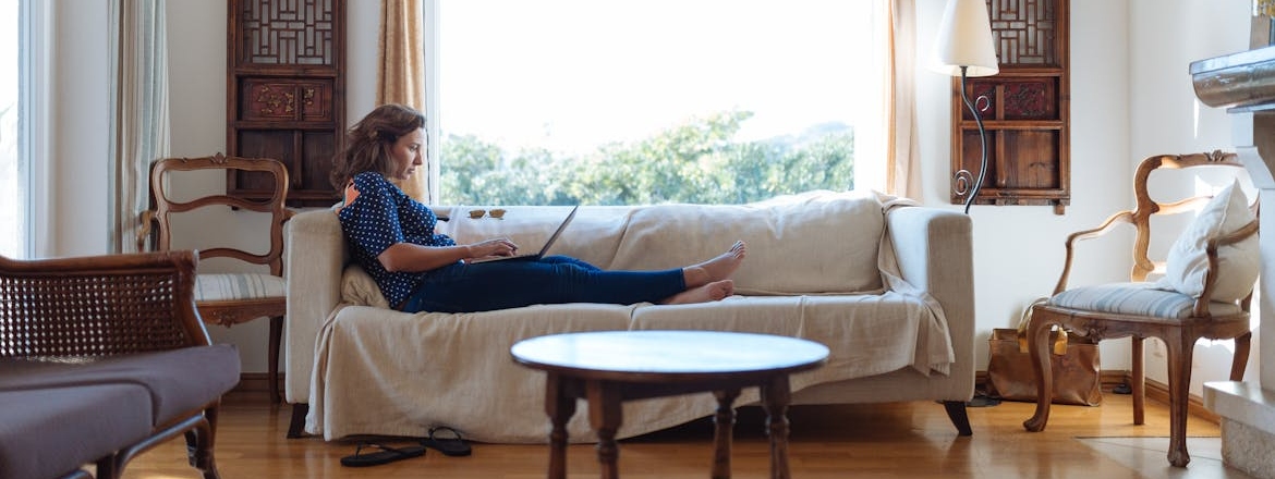 A woman sitting on a sofa in a living room.