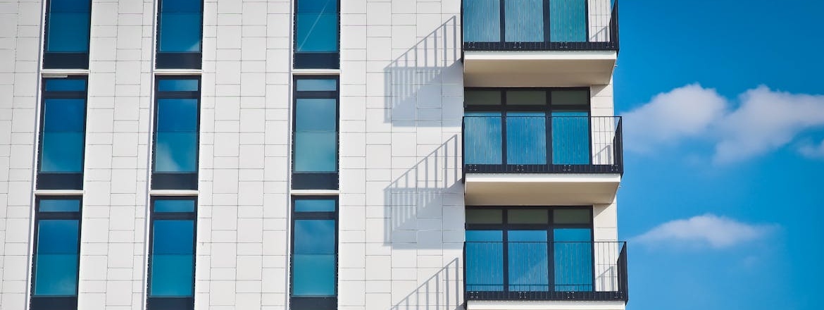 Windows on a white apartment building.